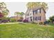 Well-maintained lawn and beautiful landscaping surround this two-story home with brick and siding at 3517 Elk St, Burlington, NC 27215