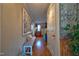 Hallway with hardwood floors, a bench, and decorative wall art leading to other rooms in the house at 3517 Elk St, Burlington, NC 27215