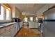 Bright eat-in kitchen featuring stainless steel appliances, white cabinets, and hardwood floors at 3517 Elk St, Burlington, NC 27215