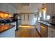 Bright kitchen featuring stainless appliances, white cabinets, and hardwood floors at 3517 Elk St, Burlington, NC 27215