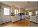 Bright eat-in kitchen with white cabinetry, stainless steel appliances, and hardwood floors at 3517 Elk St, Burlington, NC 27215