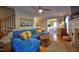 Comfortable living room with a blue sectional sofa, hardwood floors, and view into the bright eat-in kitchen at 3517 Elk St, Burlington, NC 27215
