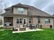 Backyard featuring a covered patio with grill, outdoor furniture, and a lush grassy lawn at 4103 Cheek Point Pl, Burlington, NC 27215