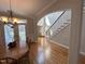 Welcoming entryway featuring hardwood floors, an elegant staircase, and an arched doorway leading to other rooms at 4103 Cheek Point Pl, Burlington, NC 27215