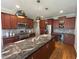 Modern kitchen featuring stainless steel appliances, granite countertops, and dark cabinets with a wine fridge at 4103 Cheek Point Pl, Burlington, NC 27215