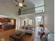 Spacious living room with an open layout, hardwood floors, high ceilings, and a view of the kitchen at 4103 Cheek Point Pl, Burlington, NC 27215