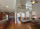 Open-concept living area showcasing hardwood floors, two story ceilings, and seamless transition to dining and kitchen at 4103 Cheek Point Pl, Burlington, NC 27215