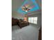 Cozy main bedroom features a tray ceiling with recessed lighting, neutral paint, and large window at 4103 Cheek Point Pl, Burlington, NC 27215