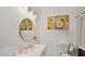Stylish bathroom with a decorative mirror, elegant vanity, and tasteful floral artwork at 423 Orange Heights Rd, Hillsborough, NC 27278