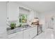 Bright kitchen featuring white cabinets, granite countertops, stainless steel appliances, and a window at 423 Orange Heights Rd, Hillsborough, NC 27278