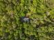Aerial view of a secluded home nestled among lush trees, offering privacy and natural beauty at 480 Big Branch Dr, Pittsboro, NC 27312
