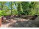 Expansive back deck with built in seating surrounded by lush greenery, perfect for entertaining at 480 Big Branch Dr, Pittsboro, NC 27312