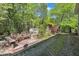 Backyard deck with seating and a view of the storage shed and lush greenery at 480 Big Branch Dr, Pittsboro, NC 27312