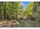 Spacious backyard with a view of the house, storage shed, and lush greenery at 480 Big Branch Dr, Pittsboro, NC 27312