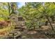 Picturesque backyard with a deck, a stone table set, and beautiful landscaping at 480 Big Branch Dr, Pittsboro, NC 27312