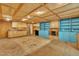Basement featuring plywood walls, a black fireplace, built-in cabinets, sink, and ample space at 480 Big Branch Dr, Pittsboro, NC 27312