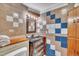 Bathroom featuring colorful tiled walls, and an antique vanity with marble countertop at 480 Big Branch Dr, Pittsboro, NC 27312