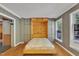 Cozy bedroom featuring a Murphy bed, built-in storage cabinets, and natural light at 480 Big Branch Dr, Pittsboro, NC 27312