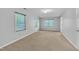 Light-filled bedroom with neutral carpet, large windows, and a peaceful ambiance, ideal for restful nights at 480 Big Branch Dr, Pittsboro, NC 27312