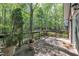 Cozy wooden deck with potted plants offering a relaxing outdoor space with views of the surrounding trees at 480 Big Branch Dr, Pittsboro, NC 27312