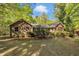 Brick home with mature landscaping showcasing the front facade and surrounding nature at 480 Big Branch Dr, Pittsboro, NC 27312