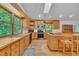 Bright kitchen with light wood cabinets, stainless steel appliances, and a breakfast bar open to the dining area at 480 Big Branch Dr, Pittsboro, NC 27312