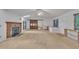 Bright living room featuring a fireplace, a large wooden door, a ceiling fan, and natural light from windows and skylights at 480 Big Branch Dr, Pittsboro, NC 27312