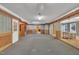 A expansive living room with a carpeted area and doorways into an adjacent room with hardwood floors at 480 Big Branch Dr, Pittsboro, NC 27312