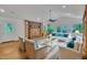 Bright living room with vaulted ceilings, brick fireplace, hardwood floors and white furnishings with blue accents at 480 Big Branch Dr, Pittsboro, NC 27312