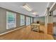 Sunlit room with wood floors, a fireplace, and French doors leading to an outdoor area at 480 Big Branch Dr, Pittsboro, NC 27312