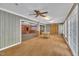 Bright living room featuring hardwood floors, a ceiling fan, and connecting doorways to other rooms at 480 Big Branch Dr, Pittsboro, NC 27312