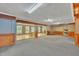 Large living room featuring wood-paneled walls, recessed lighting, and built-in shelving at 480 Big Branch Dr, Pittsboro, NC 27312