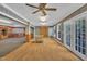 An open, bright living room showcasing hardwood floors and glass doors leading to outside at 480 Big Branch Dr, Pittsboro, NC 27312