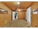 Versatile room featuring wood-paneled walls, neutral decor, and access to other rooms at 480 Big Branch Dr, Pittsboro, NC 27312