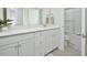 Well-lit bathroom featuring a spacious vanity, a large mirror, and a walk-in shower with glass doors at 490 Mallard Loop Dr Dr, Clayton, NC 27527