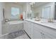 Bright bathroom with double sinks, a soaking tub, and ample countertop space at 490 Mallard Loop Dr Dr, Clayton, NC 27527