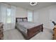 Cozy bedroom with a classic dark wood bed frame, a ceiling fan, and bright, natural light from the windows at 490 Mallard Loop Dr Dr, Clayton, NC 27527