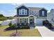 Beautiful two-story home with gray siding, a covered porch, a two car garage and a nicely landscaped front yard at 490 Mallard Loop Dr Dr, Clayton, NC 27527