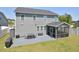 Rear exterior view of home with gray siding, screened porch, and patio at 490 Mallard Loop Dr Dr, Clayton, NC 27527