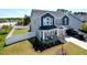 Charming two-story home featuring a welcoming front porch and well-manicured lawn, enclosed by a white fence at 490 Mallard Loop Dr Dr, Clayton, NC 27527