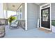 Inviting covered porch featuring comfortable seating and stylish decor, adjacent to the home's entrance at 490 Mallard Loop Dr Dr, Clayton, NC 27527