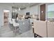 Open concept kitchen with granite island, stainless steel appliances, and adjacent dining area at 490 Mallard Loop Dr Dr, Clayton, NC 27527