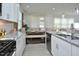 Open-concept kitchen with granite countertops, a black stove, and a view of the dining area, great for entertaining at 490 Mallard Loop Dr Dr, Clayton, NC 27527