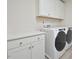 Well-organized laundry room with white cabinets and modern, front-loading washer and dryer at 490 Mallard Loop Dr Dr, Clayton, NC 27527