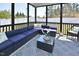 Comfortable screened porch with blue cushioned seating and patterned rug, perfect for relaxation at 490 Mallard Loop Dr Dr, Clayton, NC 27527