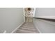 Carpeted stairs lead down to a stylish entryway with a console table and round mirror at 490 Mallard Loop Dr Dr, Clayton, NC 27527
