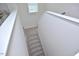 A bright stairway features carpeted steps, a window bringing in light, and white trim at 490 Mallard Loop Dr Dr, Clayton, NC 27527