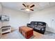 Comfortable bonus room, equipped with a ceiling fan, a leather couch, and a stylish coffee table at 518 Judge Ct, Durham, NC 27703