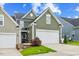 Charming home featuring a two-car garage, well-manicured lawn, and inviting curb appeal at 518 Judge Ct, Durham, NC 27703