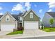 Charming home featuring a two-car garage, well-manicured lawn, and inviting curb appeal at 518 Judge Ct, Durham, NC 27703